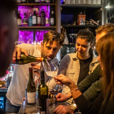 Wine guide pouring Hungarian wine for guests at Parlé Wine Bar Budapest